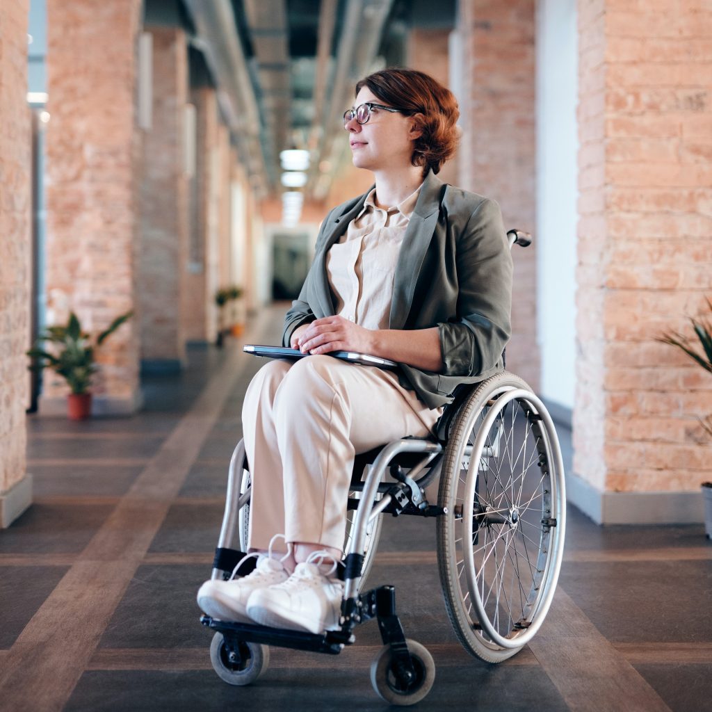 Disability is treated differently in the workplace - a person in a wheelchair looks to the left.