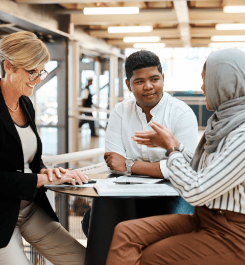 Analysis - three people at a table discussing numbers