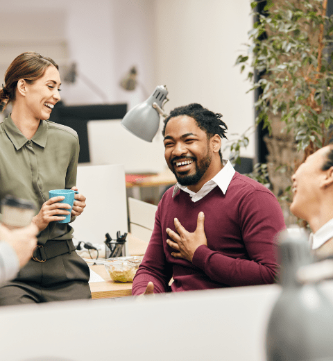 group of smiling employees during a tea break